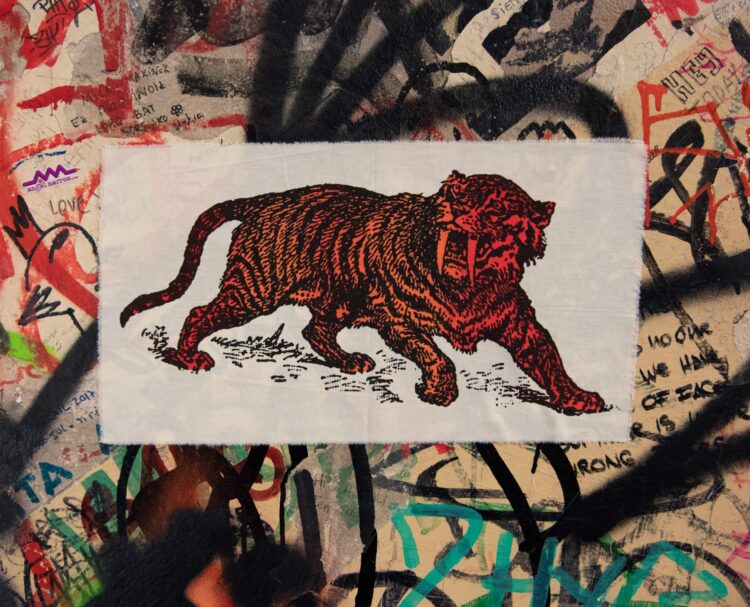 Sabre Tooth Tiger Red Orange Screenprint Back Patch on graffiti wall